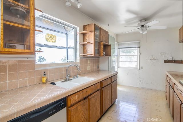 a kitchen with a sink stove and window