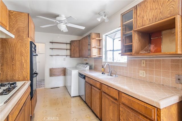 a kitchen with a sink stove and cabinets