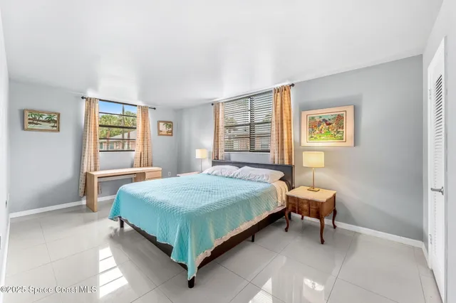 a bedroom with a bed table and a window