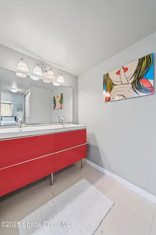 a bathroom with a sink mirror and vanity