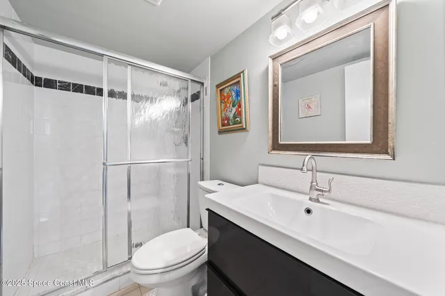 a bathroom with a toilet sink and shower