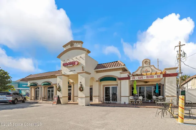 a group of people sitting in front of building
