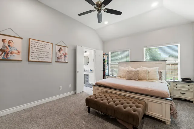 a bedroom with a bed and ceiling fan