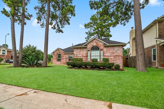 a front view of a house with a garden and yard