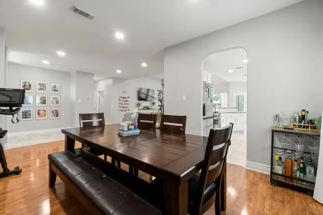 a view of a dining room with furniture and wooden floor