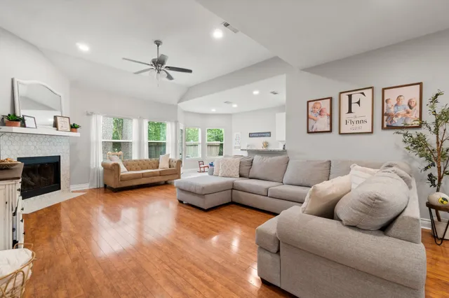 a living room with furniture and a fireplace