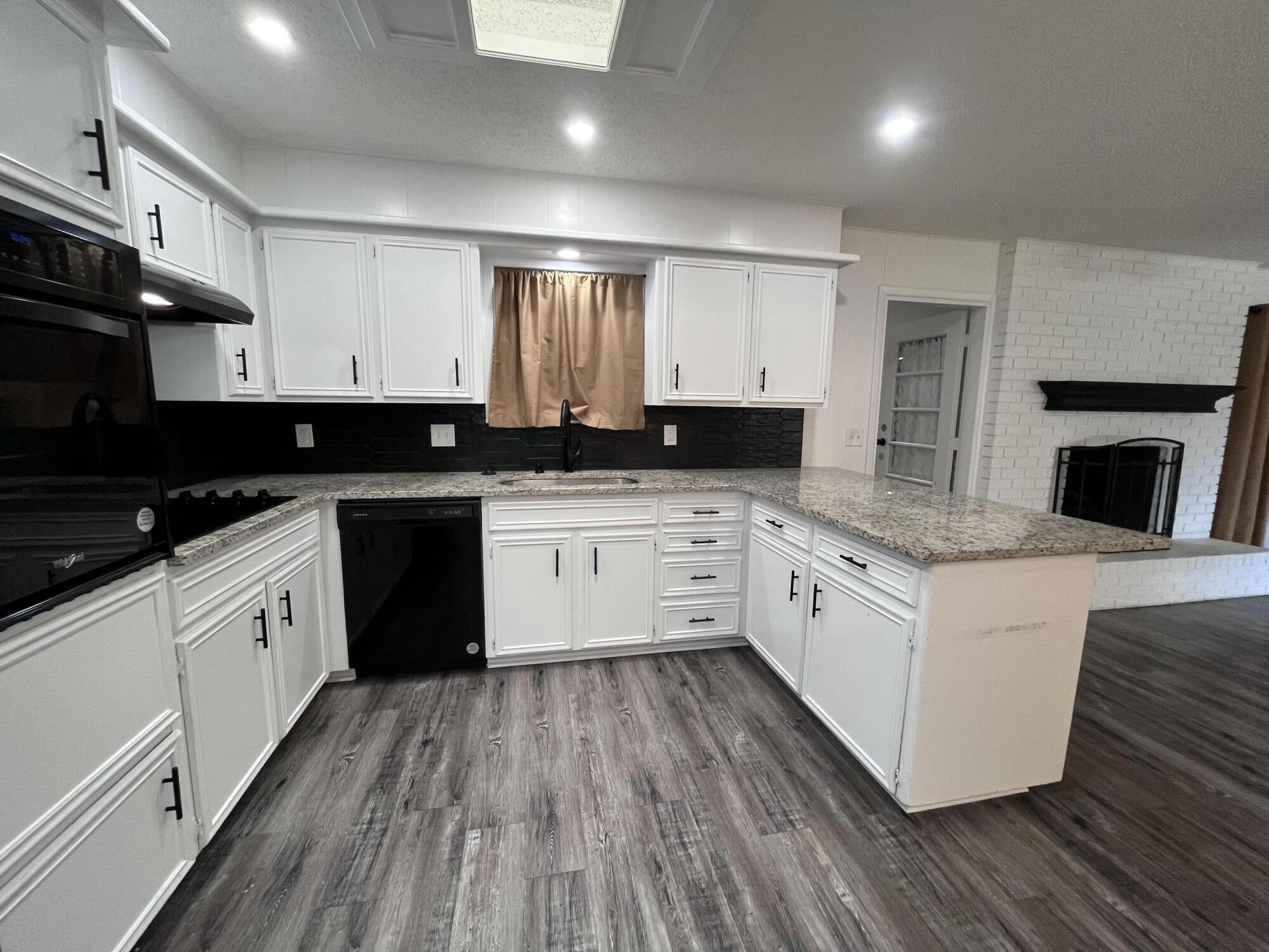 3612 55th Street Lubbock, TX 79413 - Photo 11 of 28 a white kitchen with granite countertop stainless steel appliances