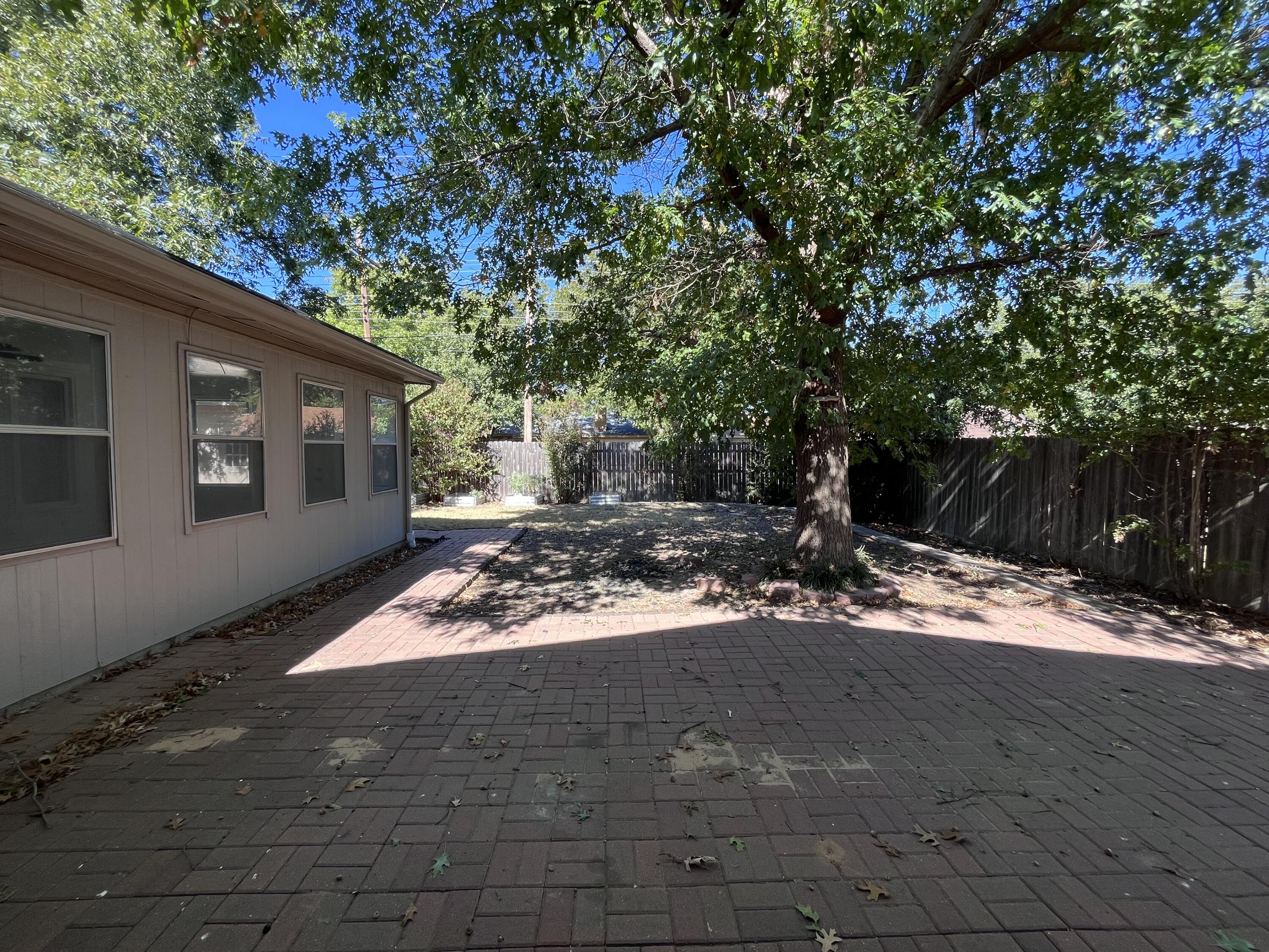 3612 55th Street Lubbock, TX 79413 - Photo 28 of 28 a view of a yard with plants and trees