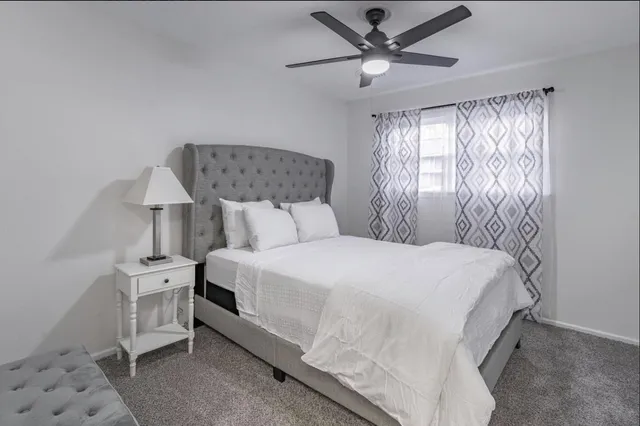 a bedroom with a bed and a window