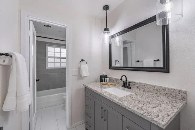 a bathroom with a sink vanity and mirror
