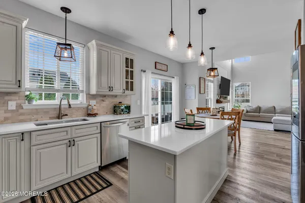 a kitchen with sink stove and cabinets