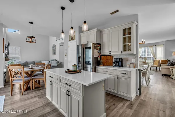 a kitchen with stainless steel appliances kitchen island granite countertop a sink a stove and a center island