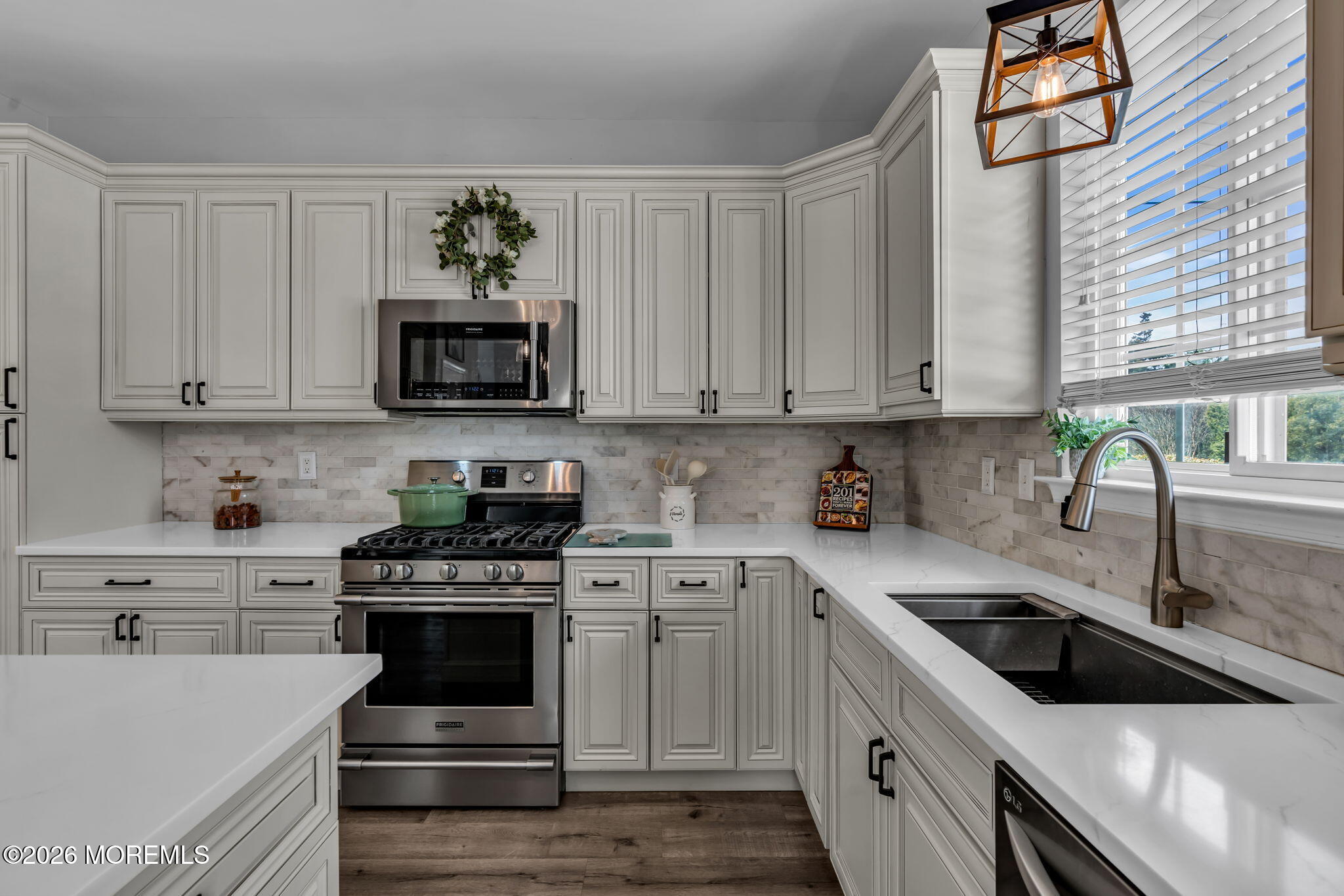 12 Lancaster Way Jackson, NJ 08527 - Photo 17 of 54 a kitchen with stainless steel appliances granite countertop a sink a stove and a microwave