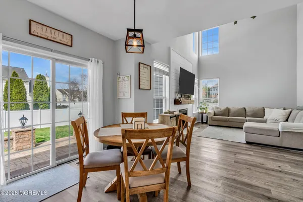 a view of a dining room with furniture large windows and wooden floor