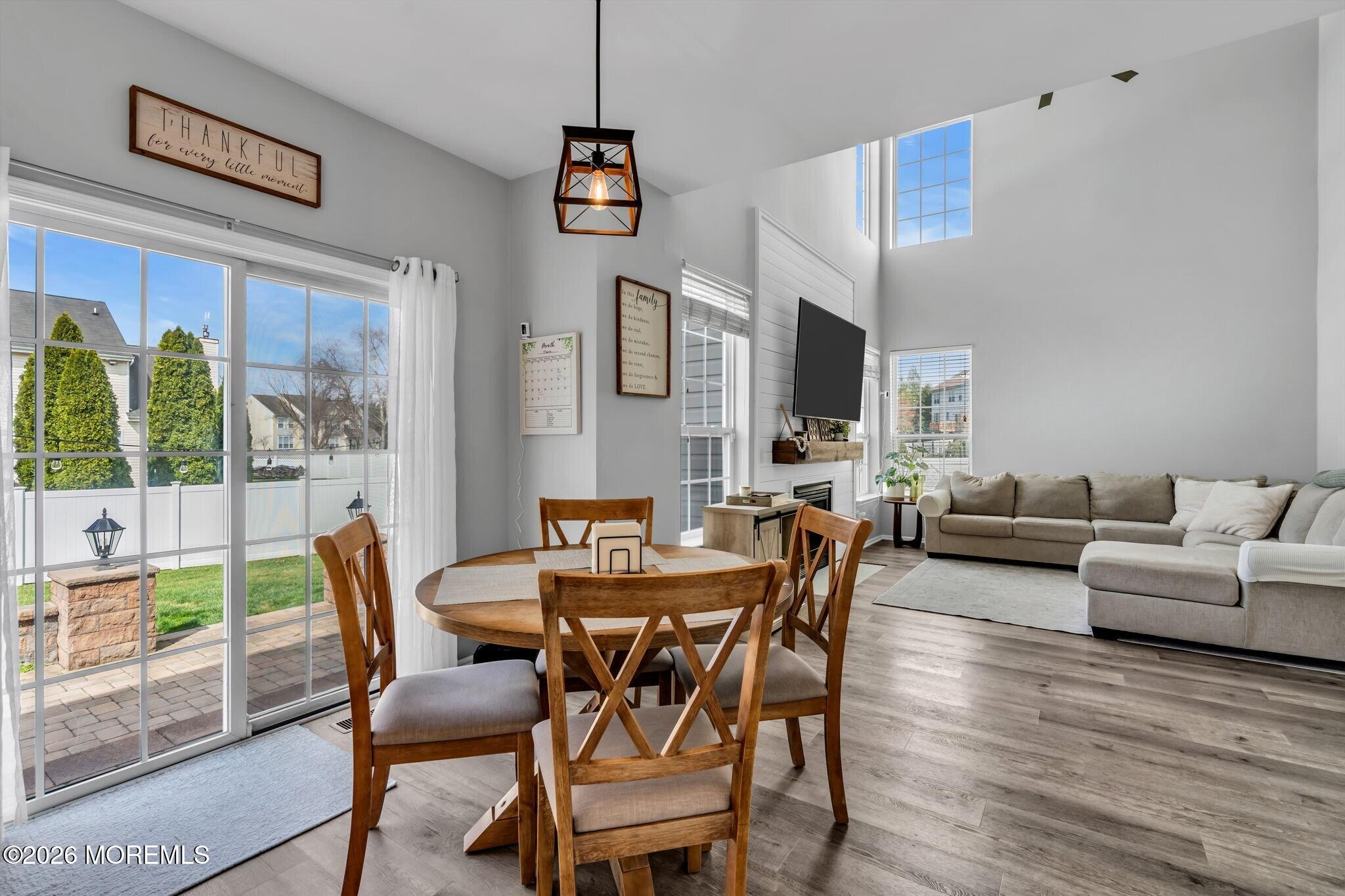 12 Lancaster Way Jackson, NJ 08527 - Photo 22 of 54 a view of a dining room with furniture large windows and wooden floor