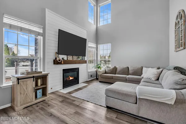 a living room with furniture a fireplace and a flat screen tv