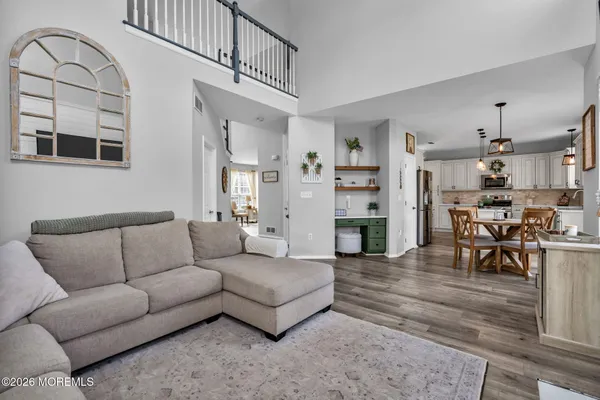 a living room with furniture and kitchen view