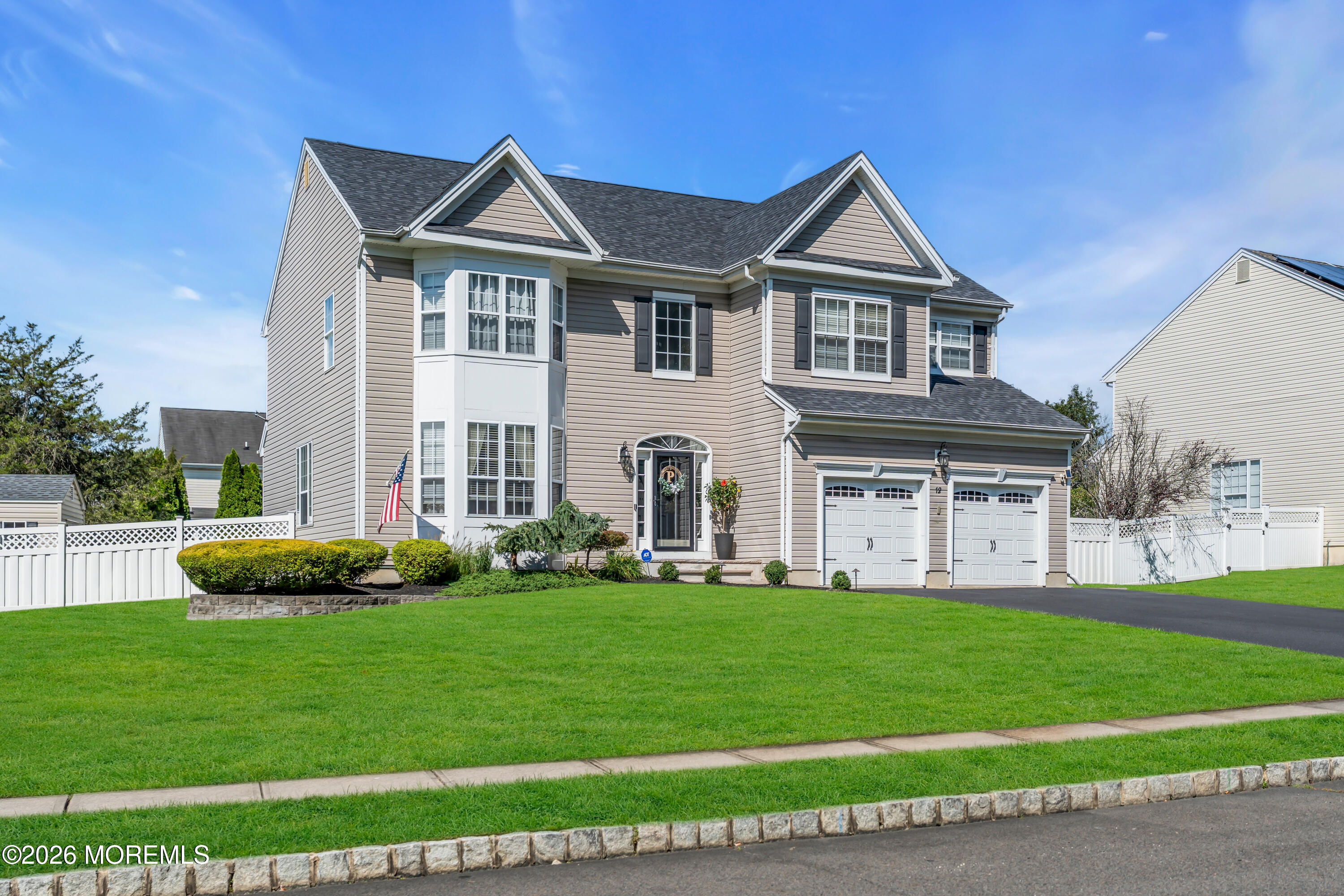 12 Lancaster Way Jackson, NJ 08527 - Photo 3 of 54 a front view of a house with a yard and garage