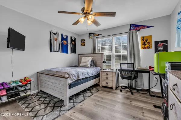 a bedroom with a bed and a chandelier