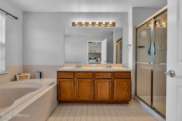 a bathroom with a tub sink and mirror