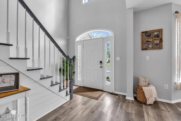 a view of an entryway with wooden floor and stairs