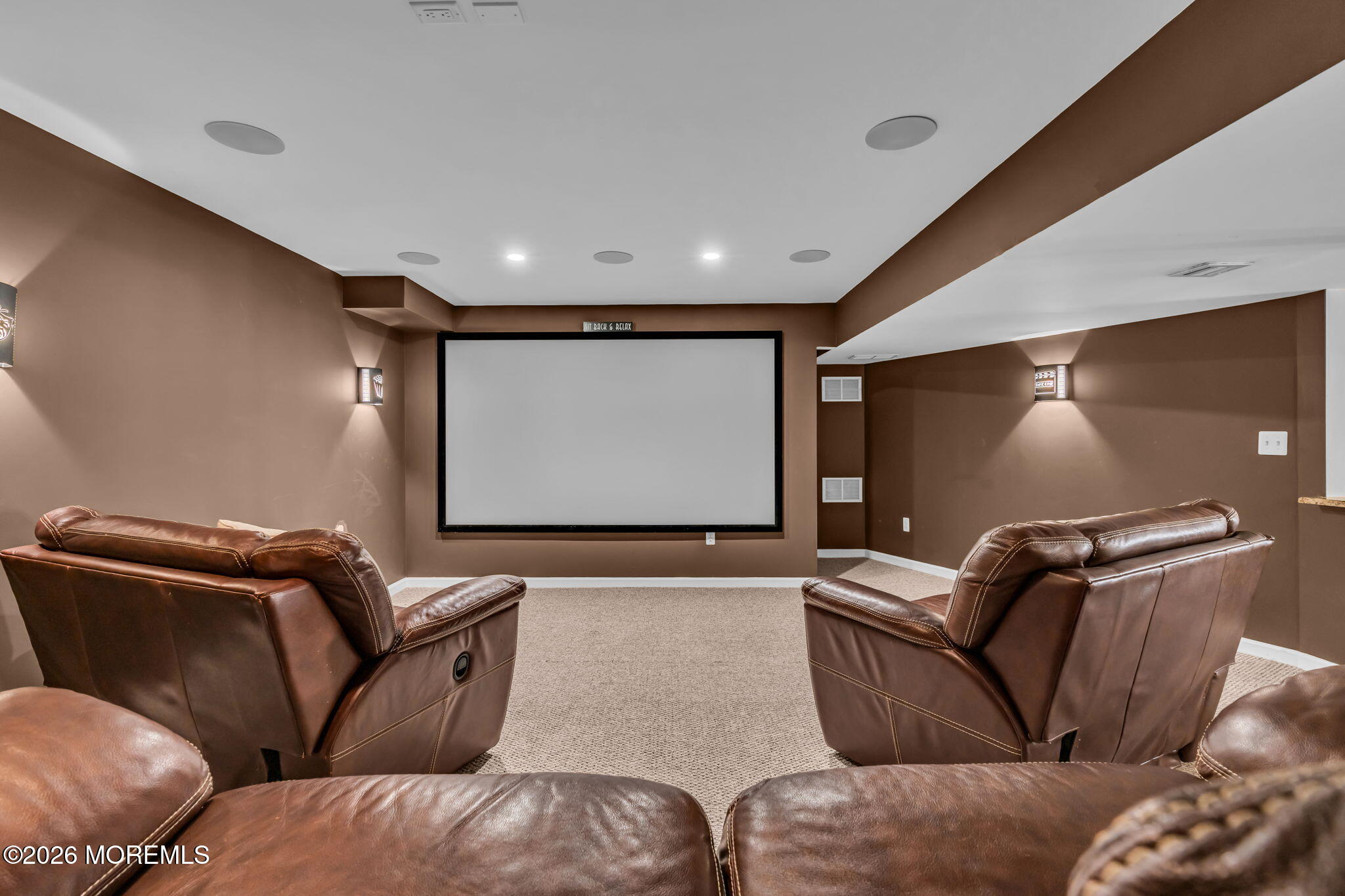 12 Lancaster Way Jackson, NJ 08527 - Photo 44 of 54 a projector room with couches and a projector with a projector