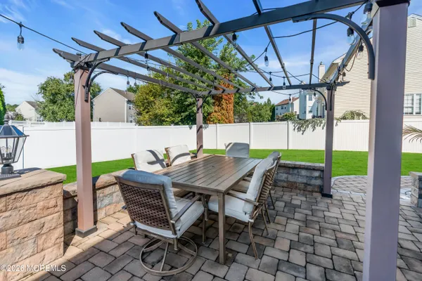 a view of a patio with couches and a table and chairs with plants