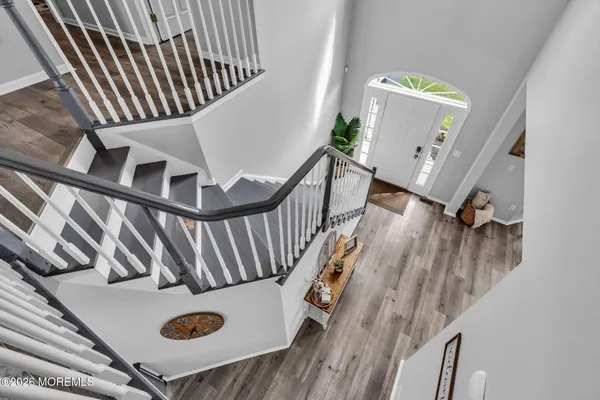 a view of entryway and hall with wooden floor