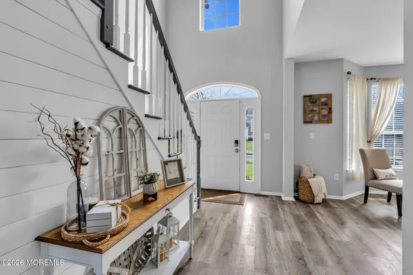 a view of entryway and hall with wooden floor