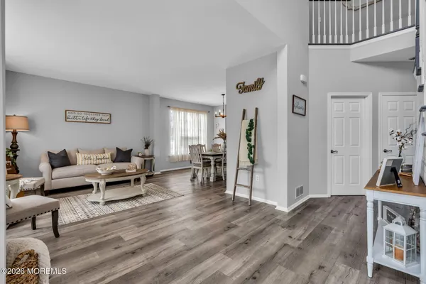 a living room with furniture and a wooden floor