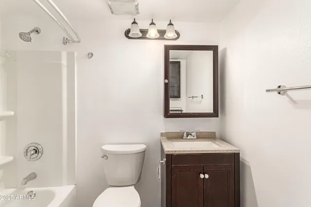 a bathroom with a sink a toilet and mirror