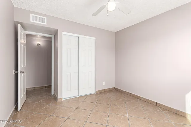 an empty room with a ceiling fan