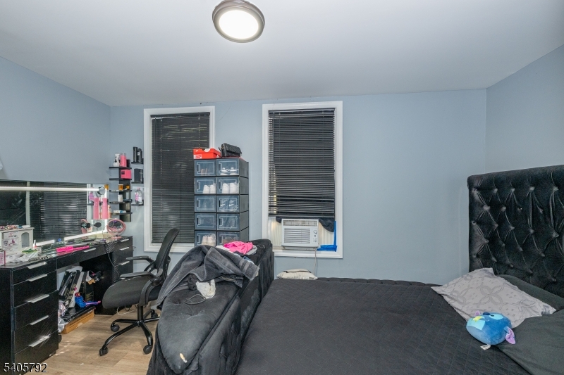 156 East Main Street Paterson, NJ 07522 - Photo 11 of 25 a bedroom with furniture and a flat screen tv