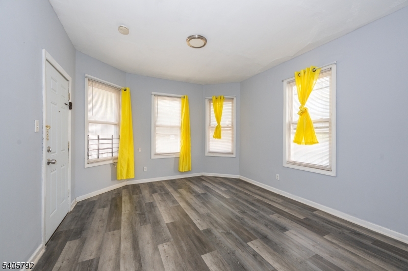 156 East Main Street Paterson, NJ 07522 - Photo 17 of 25 a view of an empty room with window and a bedroom