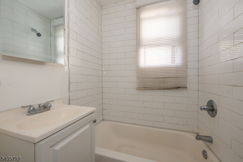 156 East Main Street Paterson, NJ 07522 - Photo 19 of 25 a bathroom with a sink and a bathtub