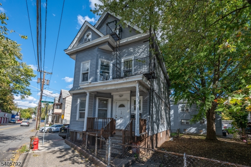 156 East Main Street Paterson, NJ 07522 - Photo 2 of 25 a house view with a sitting space and garden space