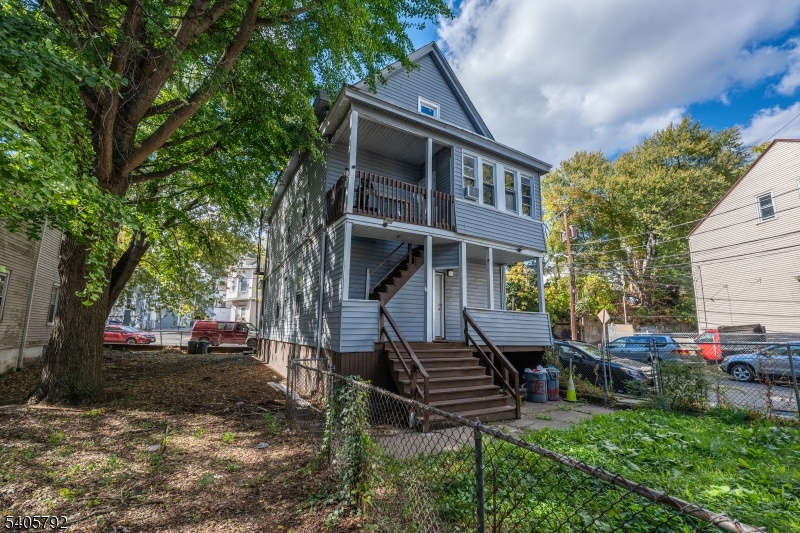 156 East Main Street Paterson, NJ 07522 - Photo 24 of 25 a view of a house with backyard and a tree