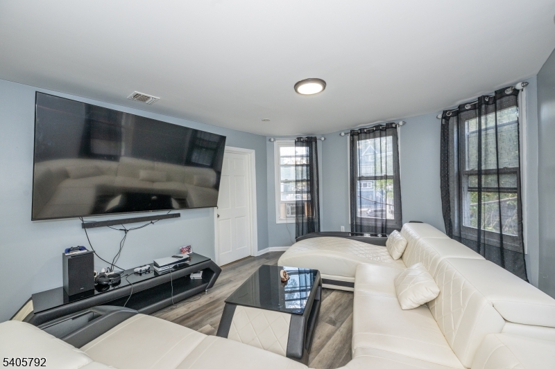 156 East Main Street Paterson, NJ 07522 - Photo 6 of 25 a bedroom with a bed and a flat screen tv