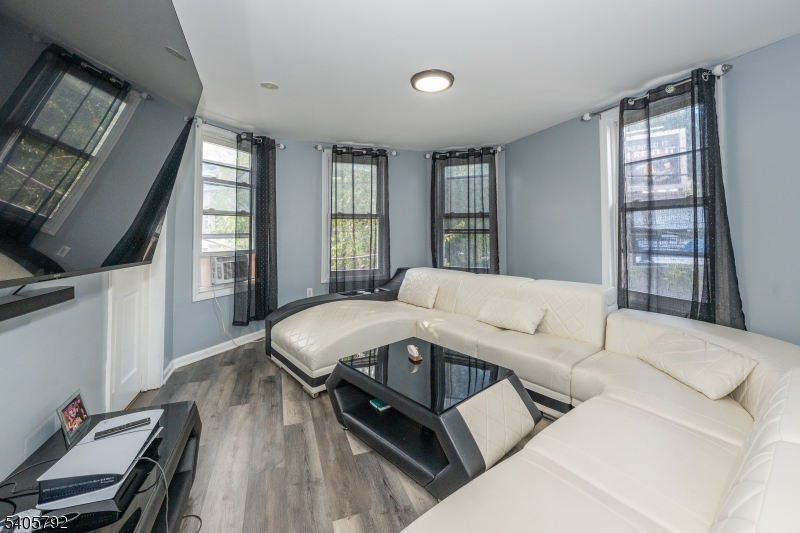 156 East Main Street Paterson, NJ 07522 - Photo 8 of 25 a living room with furniture and a window