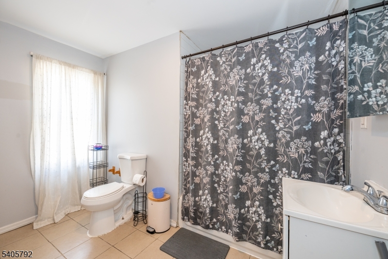 156 East Main Street Paterson, NJ 07522 - Photo 9 of 25 a bathroom with a sink toilet and shower