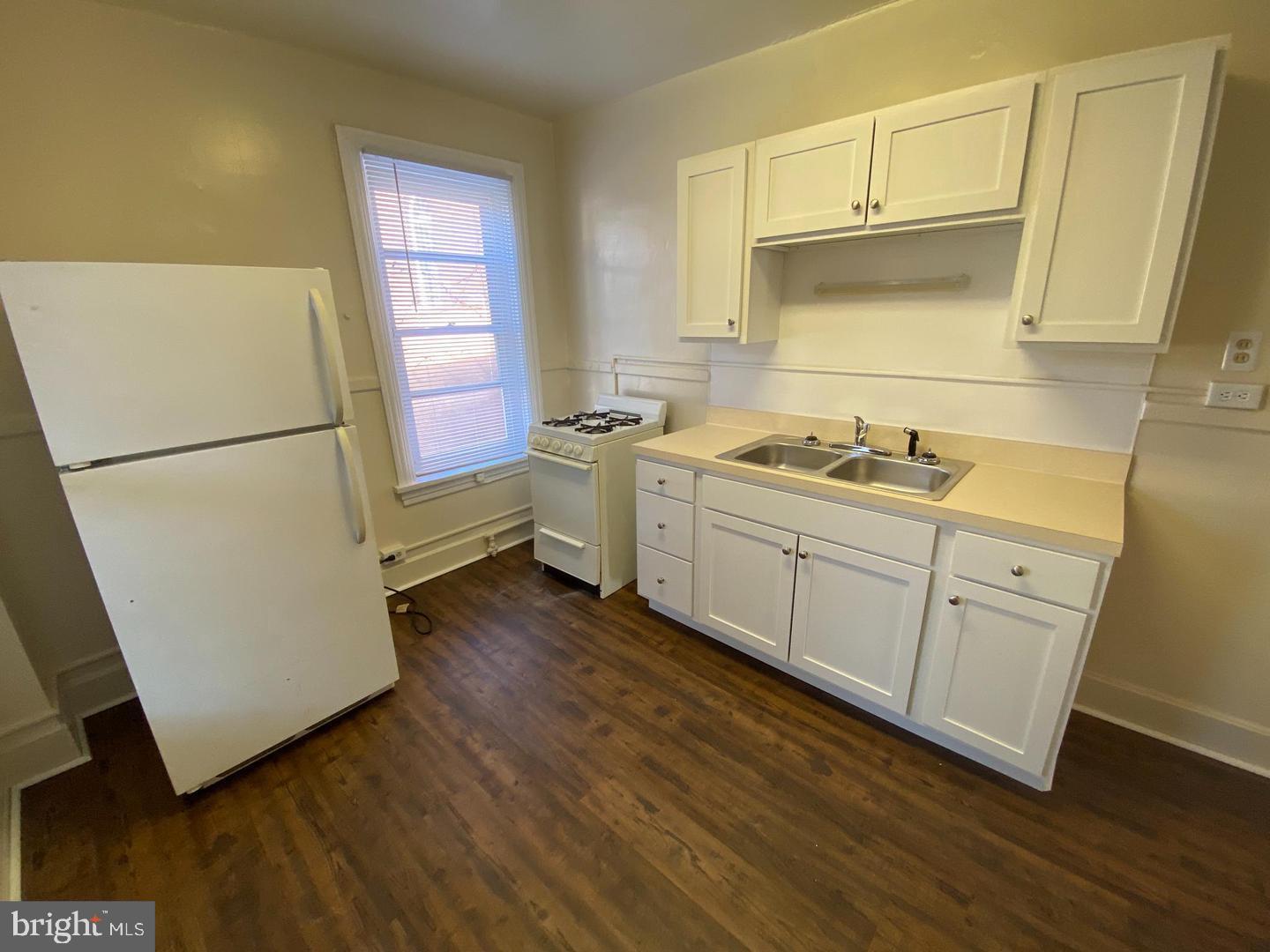 19 North Front Street Steelton, PA 17113 - Photo 4 of 14 a kitchen with sink cabinets and wooden floor