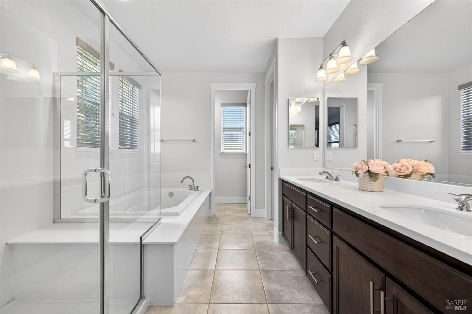 1273 Del Rancho Way Petaluma, CA 94954 - Photo 10 of 25 a spacious bathroom with a granite countertop sink a mirror and a shower