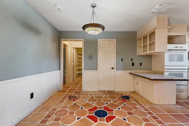 a very nice looking open kitchen with granite countertop a sink