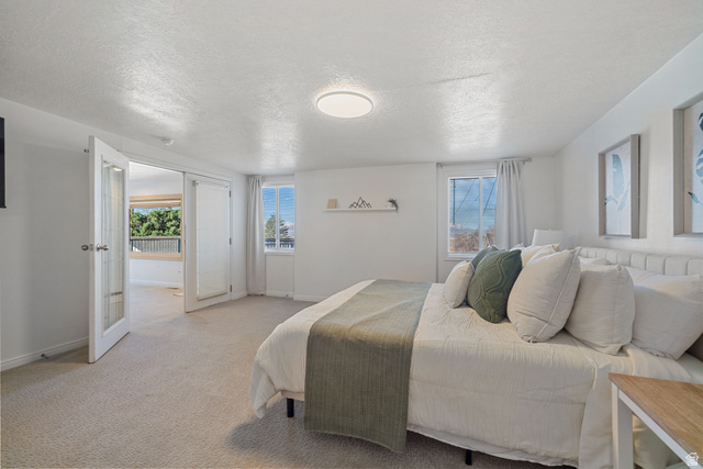 4426 South 3035 East Holladay, UT 84124 - Photo 4 of 49 Carpeted bedroom featuring a textured ceiling and baseboards