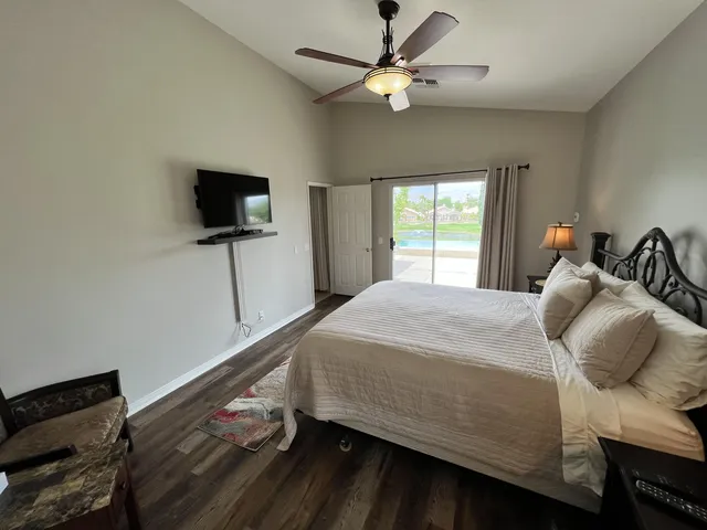 a bedroom with a bed and a flat screen tv
