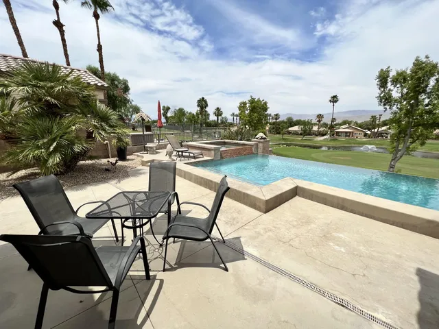 a view of a swimming pool and lounge chair