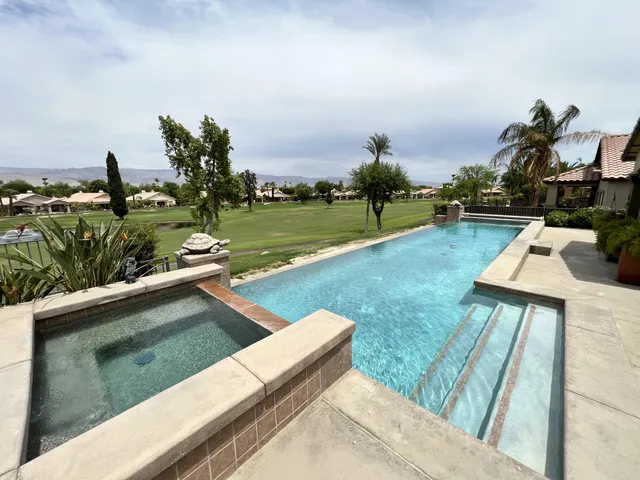 a view of a backyard with sitting area