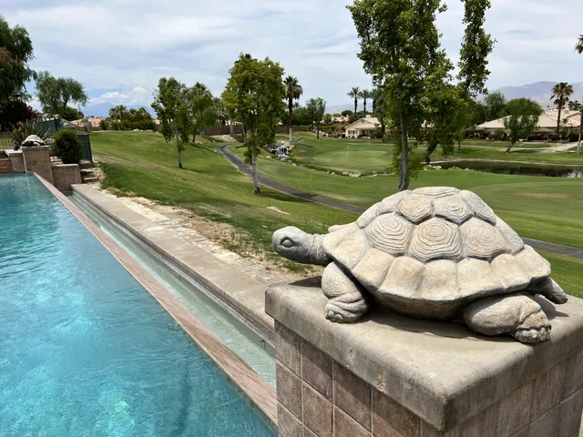 a bedroom with a bed and a flat tv screen on dresser