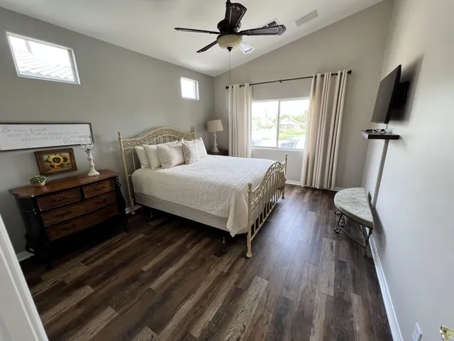 a bedroom with a bed and wooden floor