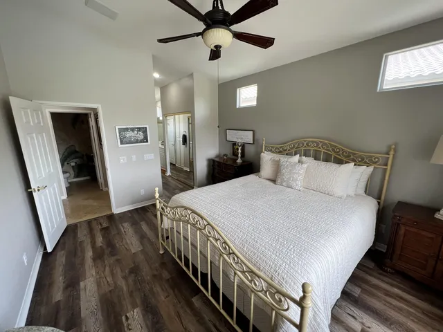 a bathroom with a sink a toilet a mirror and shower